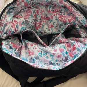 Vera Bradley weekender with double handle and crossbody strap.
